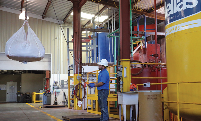 Hellas Polymers staff storing key mixing components in large tanks at Hellas Polymers - Liberty hill, TX.