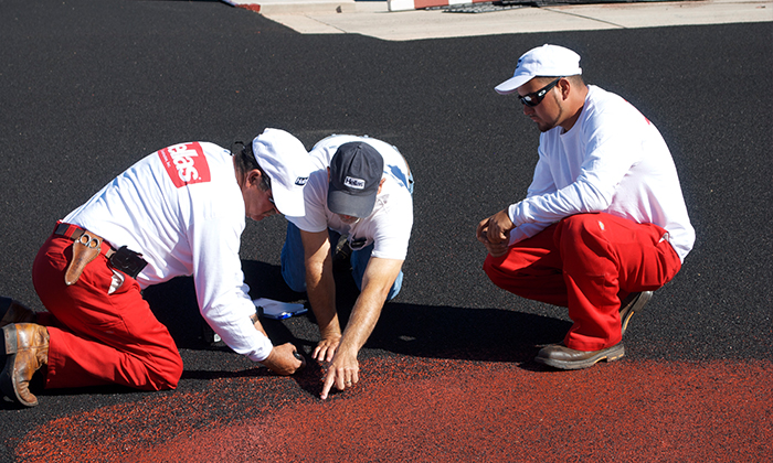 Hellas Polymers crew ensures a high level of quality by inspecting the surface for proper penetration of rubber particulates.